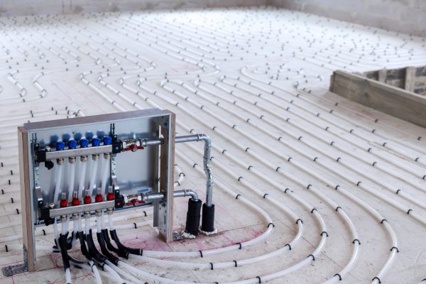 underfloor-heating-system-water-pipes-with-collector-on-the-new-picture-id1309939390